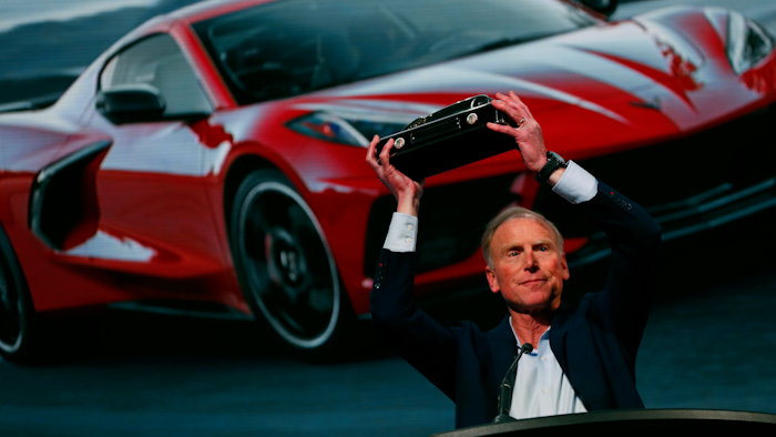 Tadge Juechter, Corvette executive chief engineer, holds up the trophy after the new mid-engine Corvette was named the North American Car of the Year in Detroit, Jan. 13, 2020.