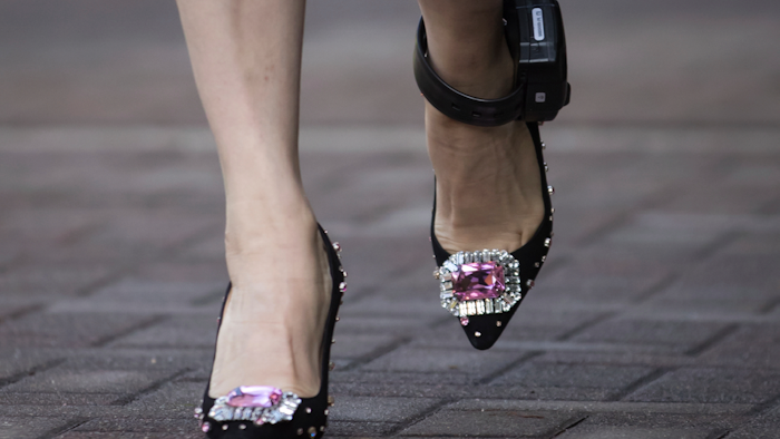 In this Sept. 24, 2019, file photo, Huawei chief financial officer Meng Wanzhou wears an electronic monitoring bracelet as she leaves her home to attend a court hearing in Vancouver.