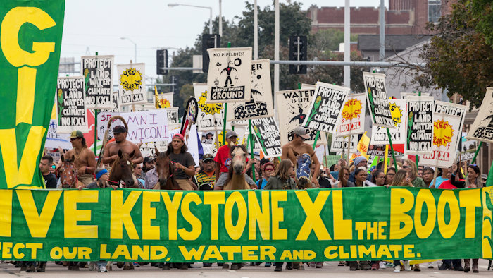 In this Aug. 6, 2017, file photo, demonstrators against the Keystone XL pipeline march in Lincoln, Neb.