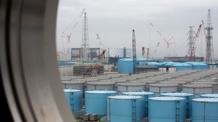 In this Feb. 23, 2017, file photo, storage tanks for contaminated water are seen through a window of a building at the Fukushima Dai-ichi nuclear power plant, Okuma town, Japan.