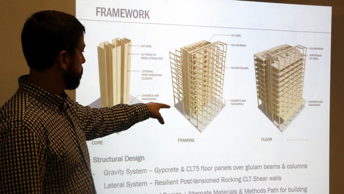 Structural engineer Eric McDonnell shows diagrams of skyscraper construction using cross-laminated timber at Portland State University, Portland, Ore., Nov. 15, 2016.
