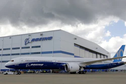 Boeing employees stand near an 787-10 Dreamliner after its first test flight, North Charleston, S.C., March 31, 2017.