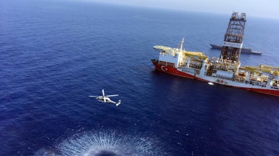 In this July 9, 2019, photo, a helicopter flies near Turkey's drilling ship 'Fatih.'