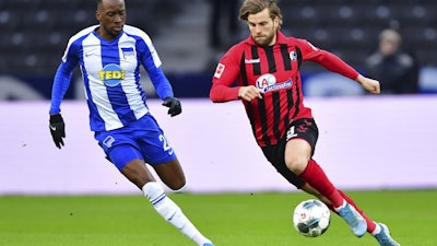 Hertha's Dodi Lukebakio, left, and Freiburg's Lucas Hoeler, right, during a match between Hertha BSC Berlin and SC Freiburg in Berlin, Dec. 14, 2019.