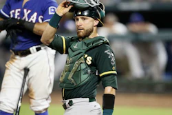 Oakland Athletics catcher Jonathan Lucroy looks to the dugout during a baseball game against the Texas Rangers, July 24, 2018, in Arlington, Texas.