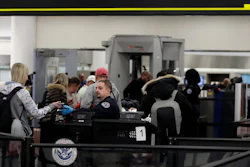 A Transportation Security Administration officer works at the entrance to Concourse G at Miami International Airport, Jan. 11, 2019.