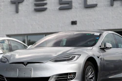 This July 8, 2018, photo shows Tesla 2018 Model 3 sedans on display outside a showroom in Littleton, Colo.