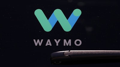 Waymo logo on the window of a car at the Google I/O conference in Mountain View, Calif., May 8, 2018.