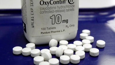 This Feb. 19, 2013, file photo shows OxyContin pills arranged for a photo at a pharmacy in Montpelier, Vt.
