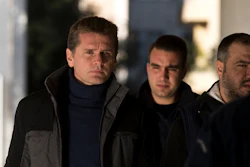In this Dec. 13, 2017, file photo, Russian cybercrime suspect Alexander Vinnik, left, arrives at Greece's supreme court in Athens.