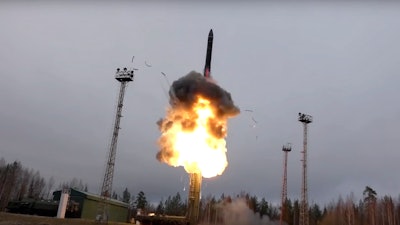 In this photo, taken from undated footage distributed by Russian Defense Ministry Press Service, an intercontinental ballistic missile lifts off from a truck-mounted launcher.