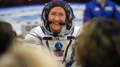 In this March 14, 2019, file photo, U.S. astronaut Christina Koch speaks with her relatives prior the launch of a Soyuz MS-12 space ship at the Baikonur cosmodrome, Kazakhstan.