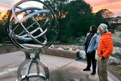 In this Dec. 11, 2019, photo Bill Donahue, right, a retired teacher and director of laboratories at St. John's College, and student Devin Ketch use an armillary sphere to track planetary rotations in Santa Fe, N.M.