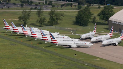 In this May 24, 2019, file photo, grounded Boeing 737 Max jets belonging to American Airlines are stored at Tulsa International Airport in Tulsa, Okla.
