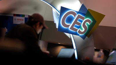 A worker helps set up a booth before CES International, Jan. 4, 2020, in Las Vegas.