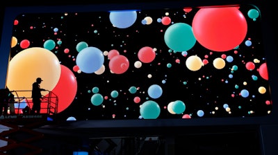 A worker helps set up the Google booth before CES International, Jan. 4, 2020, in Las Vegas.