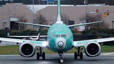 In this Dec. 11, 2019, file photo, a Boeing 737 Max taxis before a test flight at Renton Municipal Airport, Renton, Wash.
