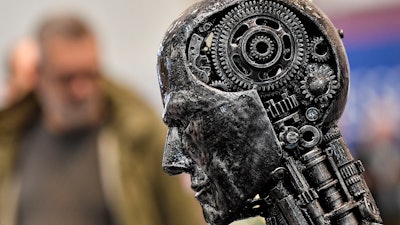 In this Nov. 29, 2019, file photo, a metal head made of motor parts, symbolizing artificial intelligence, at the Essen Motor Show, Germany.