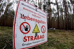 In this Jan. 8, 2020, photo, a sign warns visitors of World War II munitions at the site of the planned Tesla Gigafactory near Berlin.