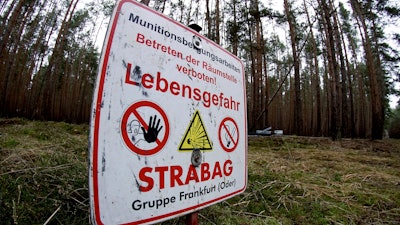 In this Jan. 8, 2020, photo, a sign warns visitors of World War II munitions at the site of the planned Tesla Gigafactory near Berlin.