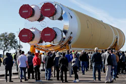 Employees and contractors watch as the core stage of NASA's Space Launch System rocket is moved to the Pegasus barge at the NASA Michoud Assembly Facility, New Orleans, Jan. 8, 2020.