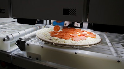 Picnic's pizza-making robot makes a pizza during the CES tech show, Jan. 8, 2020, in Las Vegas.