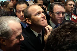In this Jan. 26, 2011, file photo, Nielsen Company CEO David Calhoun, center, watches progress as he waits for the company's IPO to begin trading on the floor of the New York Stock Exchange.