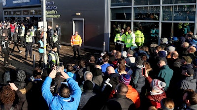 Fans crowd outside the Cardiff City stadium ahead of a match against Swansea City as South Wales police test facial recognition technology, Jan. 12, 2020.
