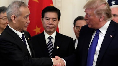 President Donald Trump shakes hands with Chinese Vice Premier Liu He after signing a trade agreement in the East Room of the White House, Jan. 15, 2020.