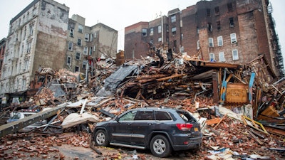 In this March 27, 2015, file photo, a pile of debris at the site of a building explosion in the East Village neighborhood of New York.