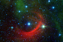 Runaway star Kappa Cassiopeiae, or HD 2905, and its bow shock captured by the Spitzer Space Telescope.