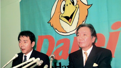 In this December 1998 photo, then-Fukuoka Daiei Hawks President Hiroshi Murakami, right, and acting owner Tadashi Nakauchi during a press conference in Fukuoka, Japan.