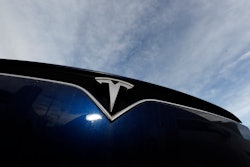 In this Nov. 10, 2019, file photo, the Tesla logo on an unsold 2020 Model X at a dealership in Littleton, Colo.