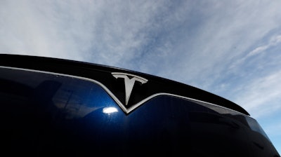 In this Nov. 10, 2019, file photo, the Tesla logo on an unsold 2020 Model X at a dealership in Littleton, Colo.