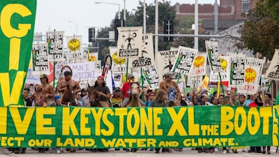 In this Aug. 6, 2017, file photo, demonstrators against the Keystone XL pipeline march in Lincoln, Neb.