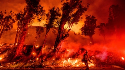 This Nov. 1, 2019, file photo shows flames from a backfire on a hillside as firefighters battle the Maria Fire in Santa Paula, Calif.