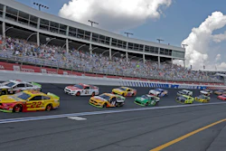In this Sept. 29, 2019, file photo, cars drive through Turn 4 to start the NASCAR Cup Series auto race at Charlotte Motor Speedway in Concord, N.C.