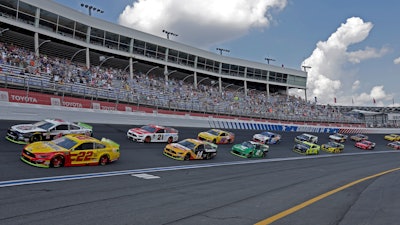 In this Sept. 29, 2019, file photo, cars drive through Turn 4 to start the NASCAR Cup Series auto race at Charlotte Motor Speedway in Concord, N.C.