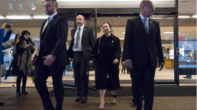 Meng Wanzhou, chief financial officer of Huawei, is flanked by security as she leaves B.C. Supreme Court in Vancouver, January 23, 2020.