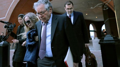 Insys Therapeutics founder John Kapoor, front, departs federal court, Jan. 23, 2020, in Boston.