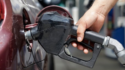 In this June 28, 2016, file photo, a customer puts gas in their vehicle in Miami.