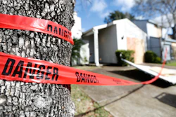 Red 'danger' tape circles a damaged home on Bridgeland Lane in Houston, Jan. 26, 2020.