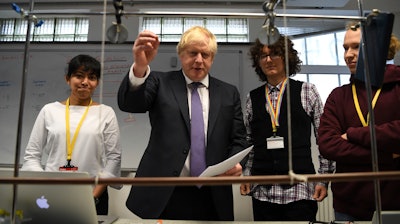 Prime Minister Boris Johnson, center left, visits the Department of Mathematics at King's Maths School, London, Jan. 27, 2020.