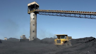 Heavy equipment moves coal, Aug. 28, 2009, outside Signal Peak Energy's Bull Mountain mine near Roundup, Mont.