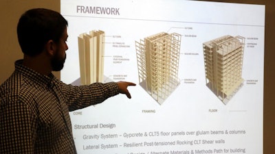 Structural engineer Eric McDonnell shows diagrams of skyscraper construction using cross-laminated timber at Portland State University, Portland, Ore., Nov. 15, 2016.