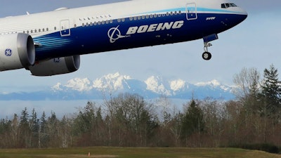 A Boeing 777X airplane takes off on its first flight at Paine Field in Everett, Wash., Jan. 25, 2020.