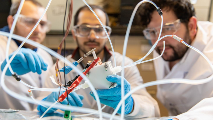 Adnan Ozden (left), Joshua Wicks and F. Pelayo García de Arquer (right) are among the team members who have designed an electrolyzer that converts CO2 to valuable products.