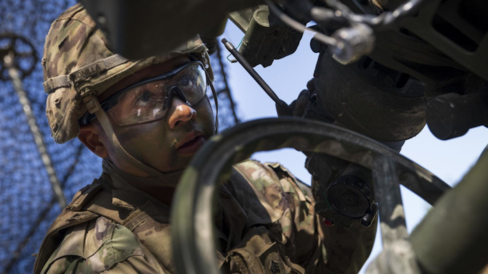 Sgt. Johnny Bonilla, a gunner and cannon crewmember with the 173rd Airborne Brigade, wears a combat helmet first fielded in the 1980s.