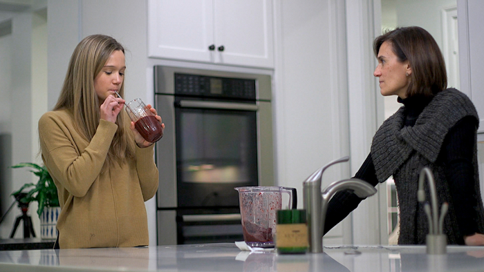 In this Jan. 10, 2020, image from video, 18-year-old Nina Nichols takes her daily dose of Palforzia as her mother, Maria Acebal, watches in her home in Washington.