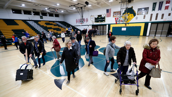 Local residents enter an Iowa Democratic caucus at Hoover High School, Feb. 3, 2020, in Des Moines.